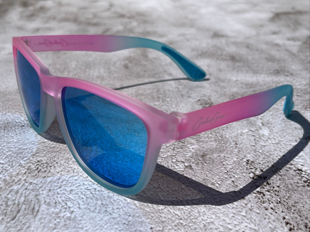 Cotton Candy Sky has a slightly transparent, light pink and light blue frame, with blue reflective lenses. The temple grips are light blue.