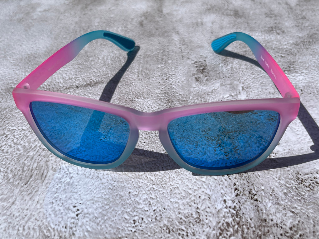 Cotton Candy Sky has a slightly transparent, light pink and light blue frame, with blue reflective lenses. The temple grips are light blue.