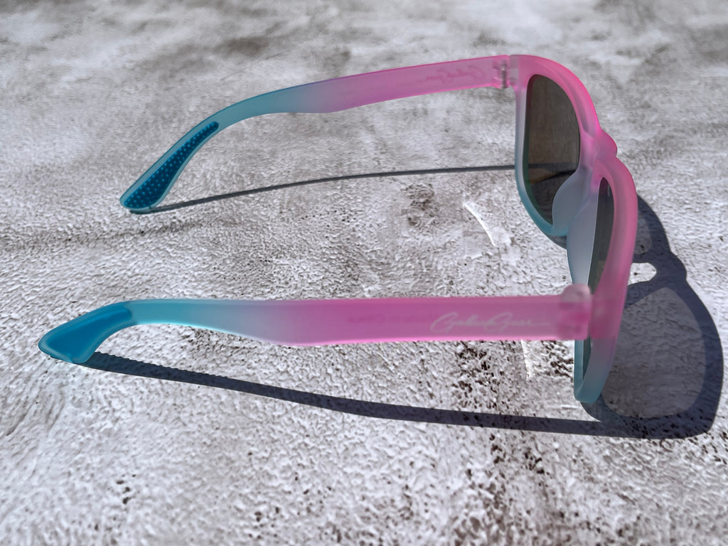Cotton Candy Sky has a slightly transparent, light pink and light blue frame, with blue reflective lenses. The temple grips are light blue.